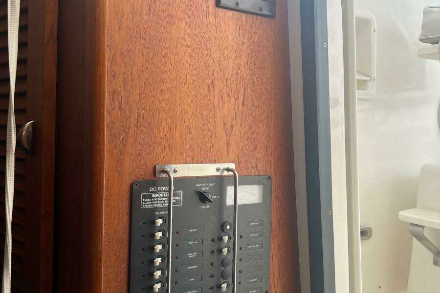 Control panel on 2001 Pursuit 3000 Offshore boat, featuring wooden finish and switches.