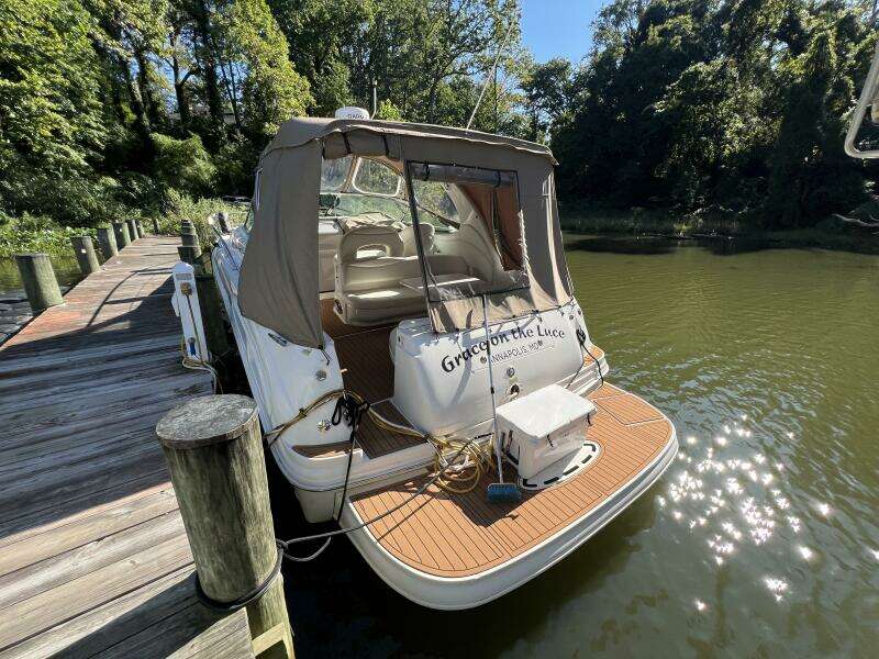 2002 Sea Ray 360 Sundancer docked, featuring a Camper Cover and Faux Teak SeaDek on the Swim Platform