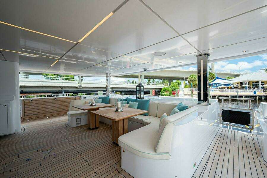 Luxurious 2020 Majesty 140 yacht deck with elegant seating and wooden flooring.