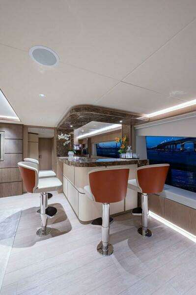 Luxurious interior of 2020 Majesty 140 yacht with elegant bar and seating.