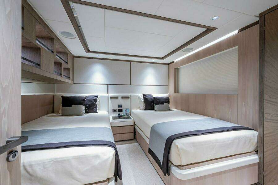 Luxurious twin bedroom in 2020 Majesty 140 yacht, featuring modern design and elegant decor.
