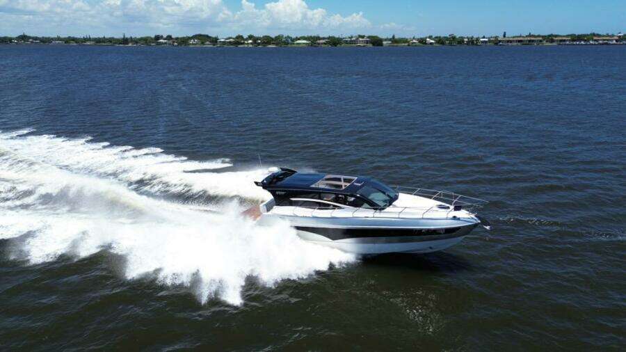 2025 Real 40 HT Luxury yacht cruising on open water, creating a dynamic wake.