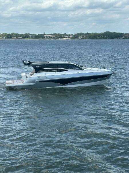 2025 Real 40 HT Luxury yacht cruising on a calm sea under a cloudy sky.