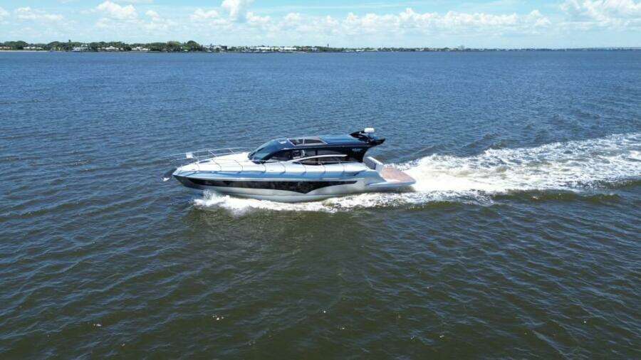 2025 Real 40 HT Luxury yacht cruising on open water under a clear sky.