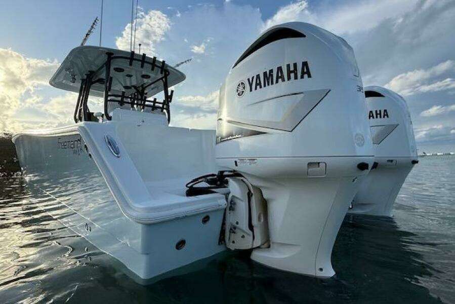 2019 Freeman 34 boat with dual Yamaha engines on calm water.
