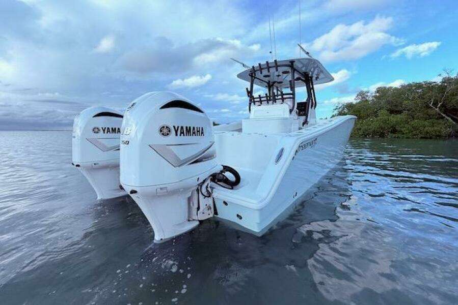 2019 Freeman 34 boat with twin Yamaha engines on calm water.