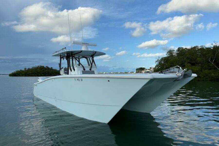 2019 Freeman 34 boat on calm water under a partly cloudy sky.