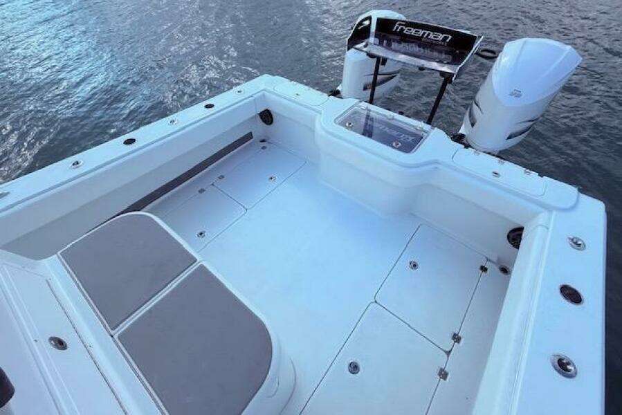2019 Freeman 34 boat deck with dual engines on calm water.