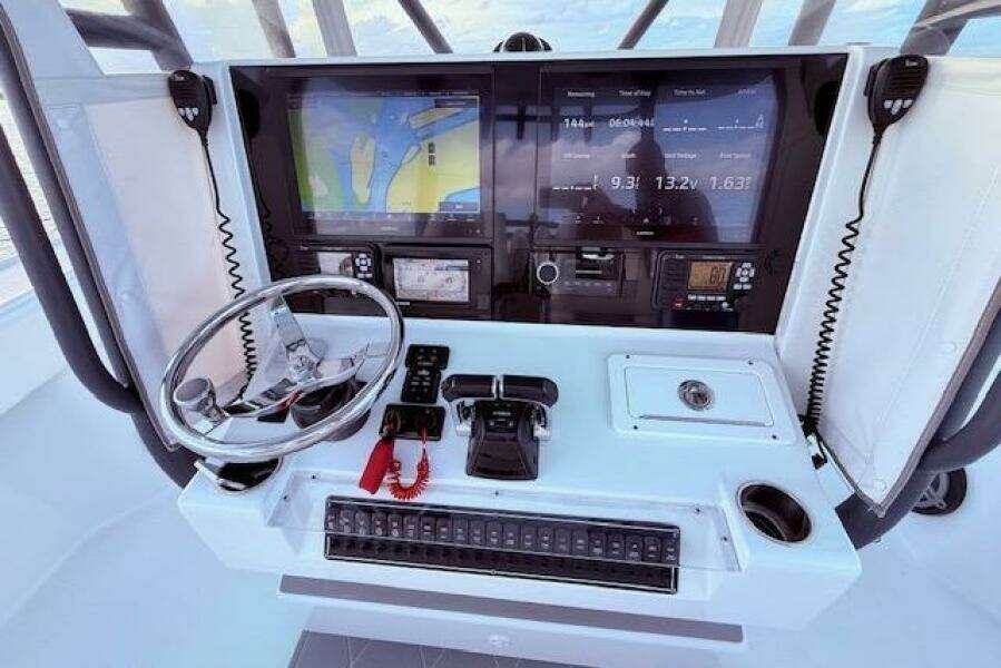 Cockpit of 2019 Freeman 34 boat with navigation screens and controls.