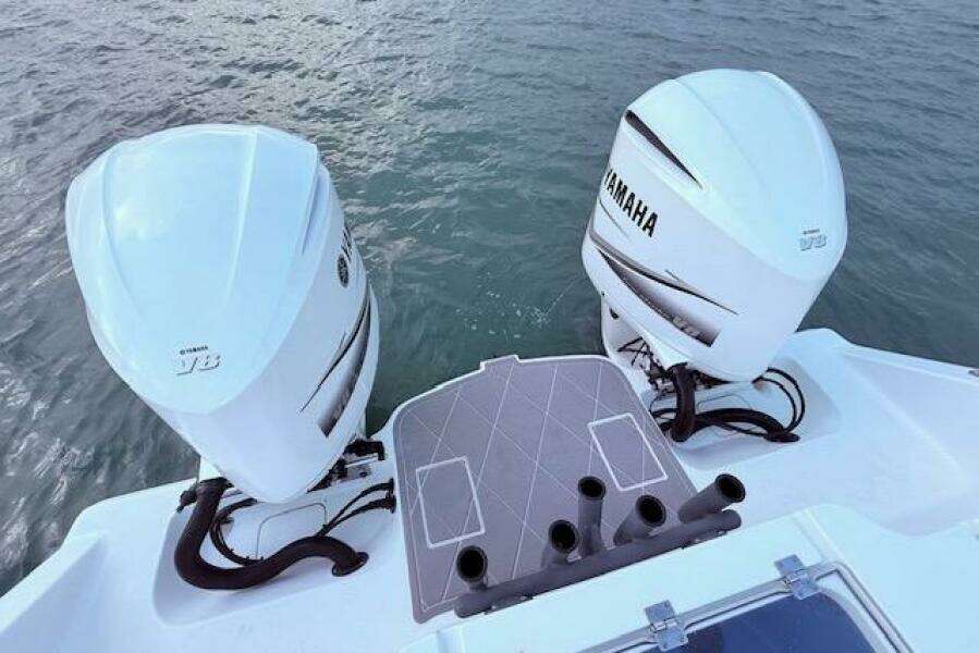 Twin Yamaha outboard engines on a 2019 Freeman 34 boat, viewed from the stern.