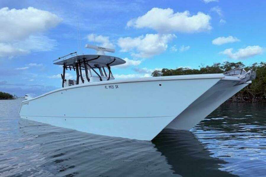 2019 Freeman 34 boat on calm water under blue sky.