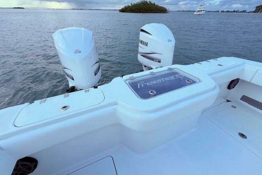 2019 Freeman 34 boat with Yamaha engines on calm water.