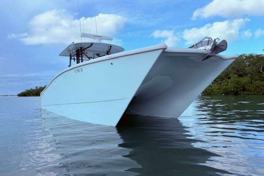 2019 Freeman 34 boat on calm water under a blue sky.