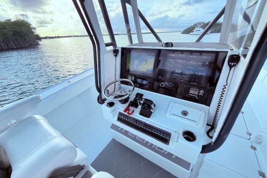 2019 Freeman 34 boat cockpit with advanced navigation system and scenic water view.