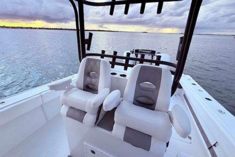 2019 Freeman 34 boat interior with dual seats, overlooking calm waters at sunset.