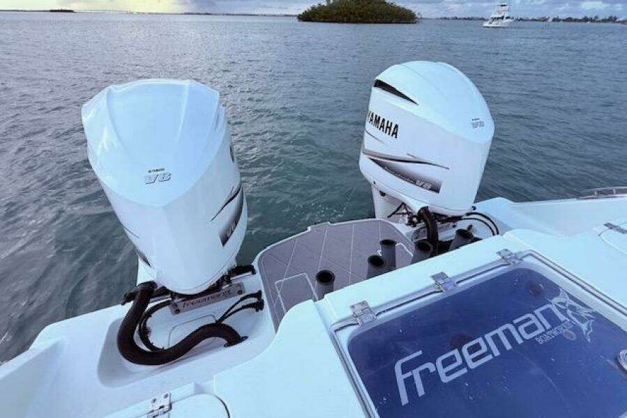 Freeman 34 boat with twin Yamaha outboard engines on a calm sea, 2019 model.