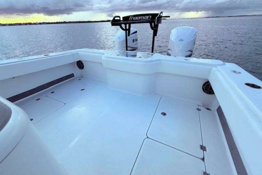2019 Freeman 34 boat deck with dual engines on calm water.