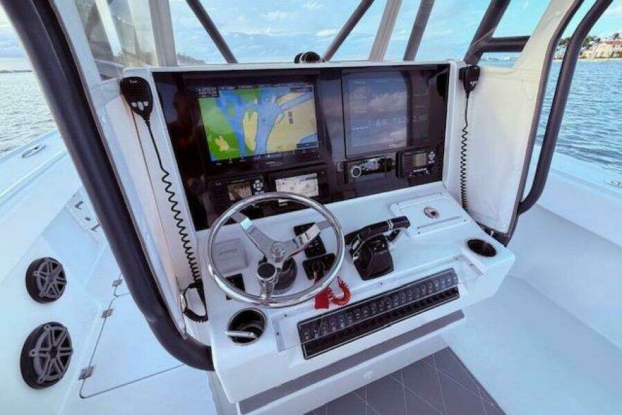 Helm of 2019 Freeman 34 boat with navigation screens and controls.