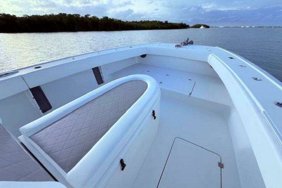 2019 Freeman 34 boat interior with cushioned seating, on calm water.