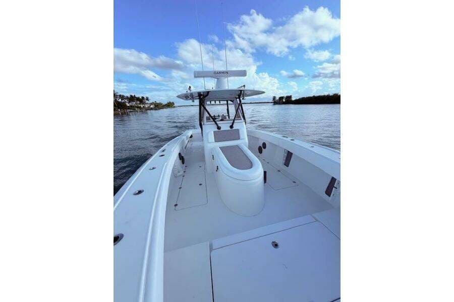 2019 Freeman 34 boat on calm water under a blue sky with clouds.
