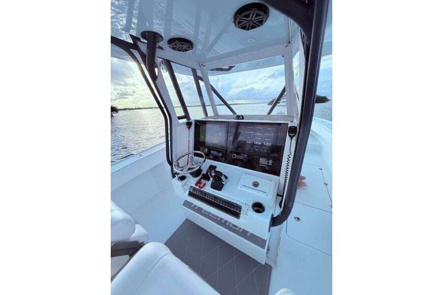 2019 Freeman 34 boat cockpit with modern navigation equipment, overlooking serene water.