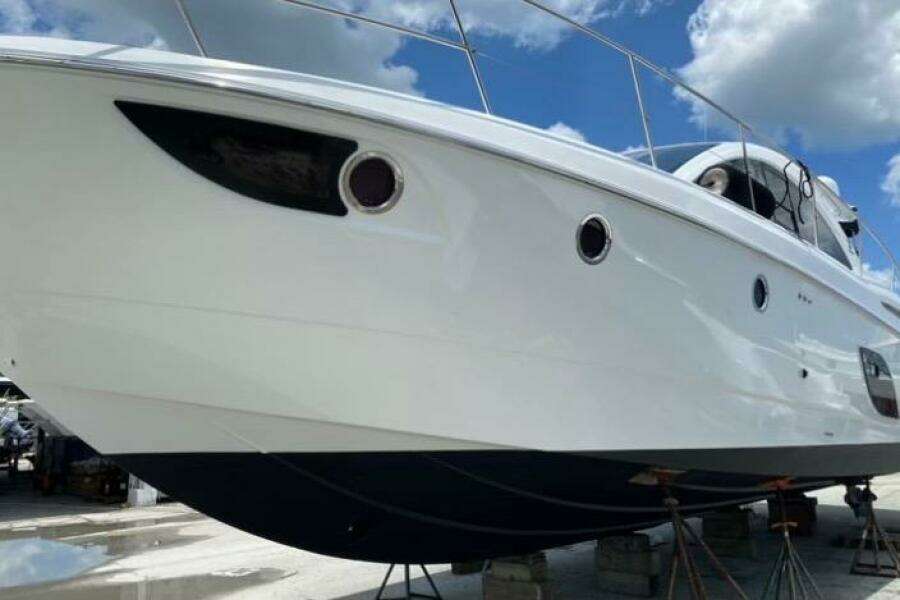 2014 Beneteau Gran Turismo 44 yacht on dry dock under a blue sky.