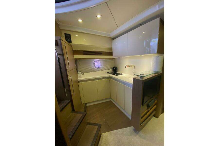 Modern kitchen interior of 2014 Beneteau Gran Turismo 44 yacht, featuring sleek cabinetry and lighting.