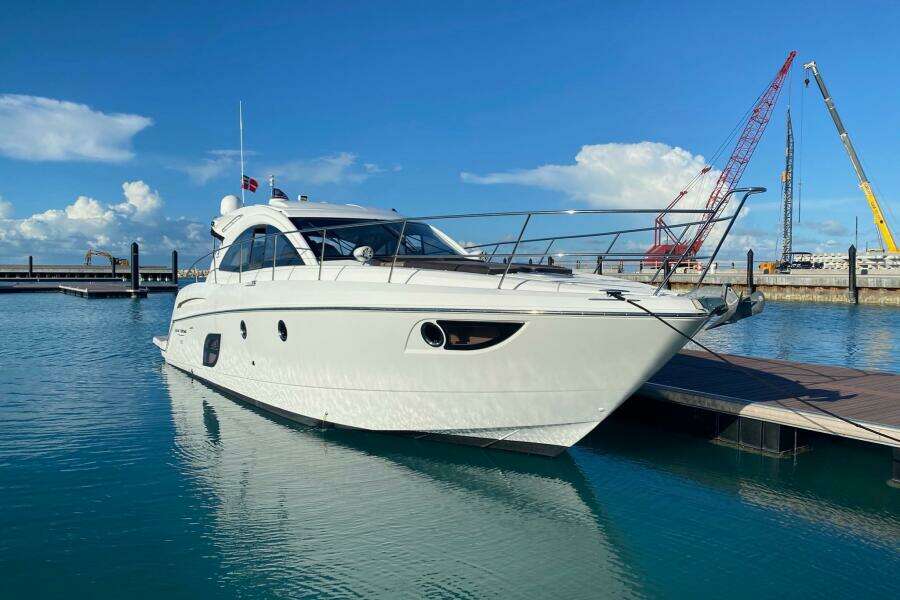 2014 Beneteau Gran Turismo 44 yacht docked in a sunny marina.