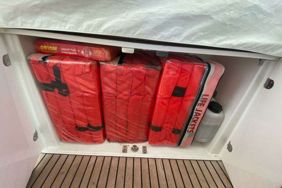 Storage compartment with life jackets and marine signal kit on a 2014 Beneteau Gran Turismo 44.