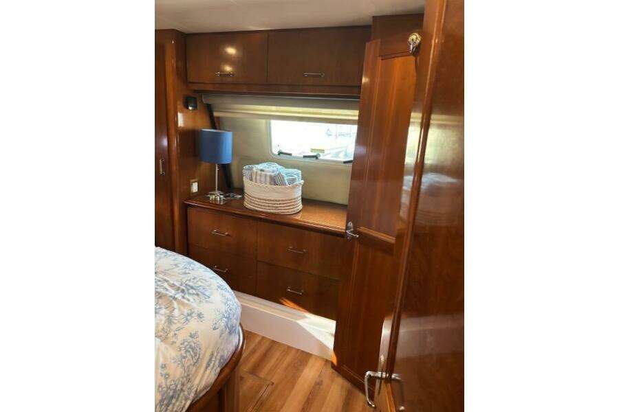 Interior of 2004 Carver 466 Motor Yacht with wooden cabinetry and cozy decor.