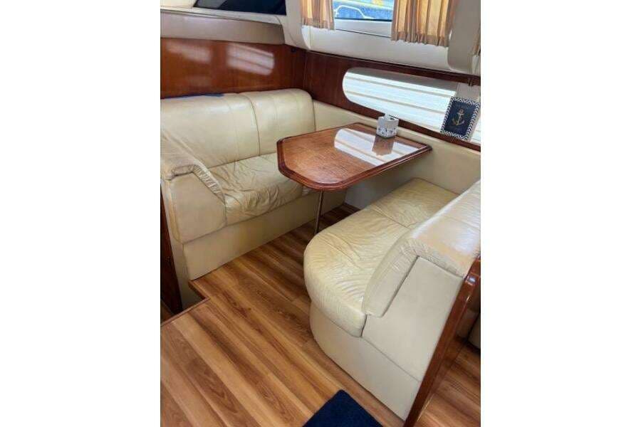2004 Carver 466 Motor Yacht interior with leather seating and wooden table.