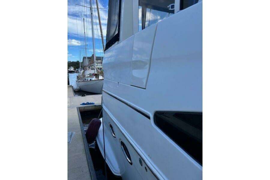 Side view of a 2004 Carver 466 Motor Yacht docked at a marina.