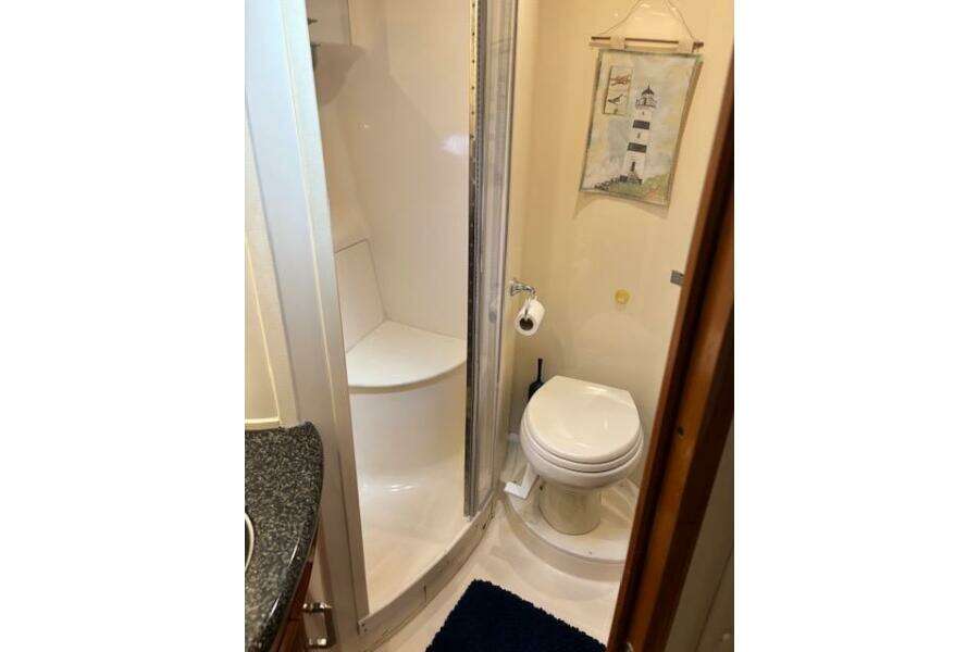 Bathroom interior of 2004 Carver 466 Motor Yacht with shower and toilet.