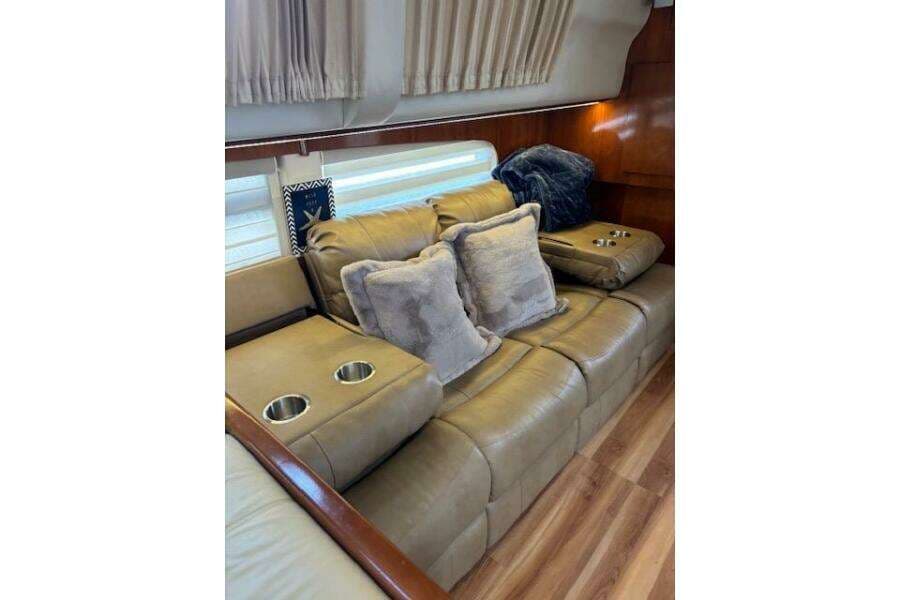 Luxurious interior of 2004 Carver 466 Motor Yacht with plush seating and cushions.