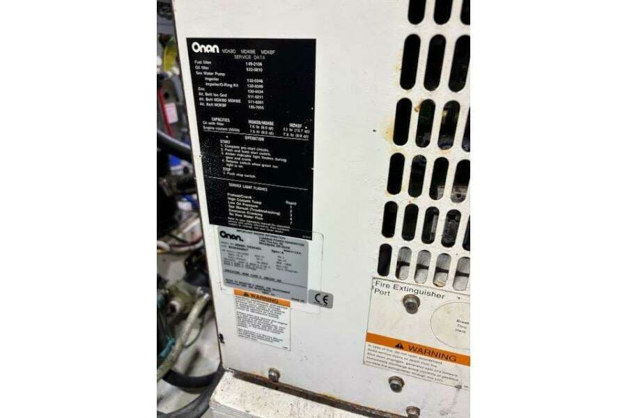 Onan generator panel on 2004 Carver 466 Motor Yacht, showing specifications and warnings.