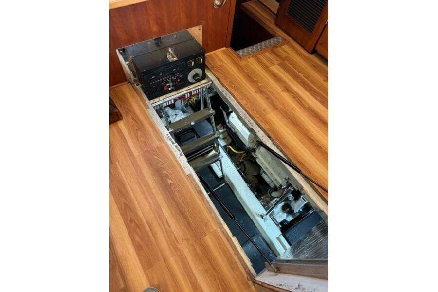 Engine compartment of 2004 Carver 466 Motor Yacht with wooden flooring.