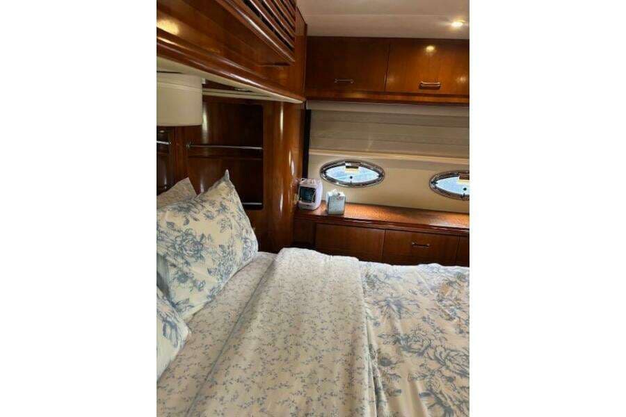 Luxurious bedroom interior of 2004 Carver 466 Motor Yacht with elegant wood finish.