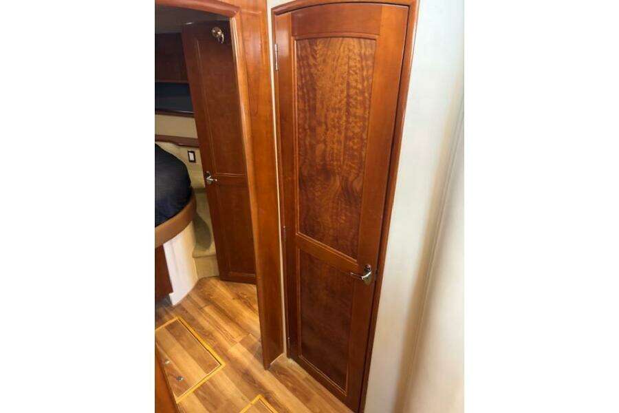 Interior of 2004 Carver 466 Motor Yacht with wooden doors and flooring.