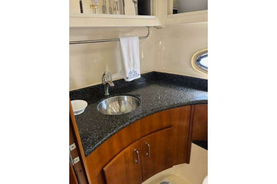 2004 Carver 466 Motor Yacht bathroom with granite countertop and sink.