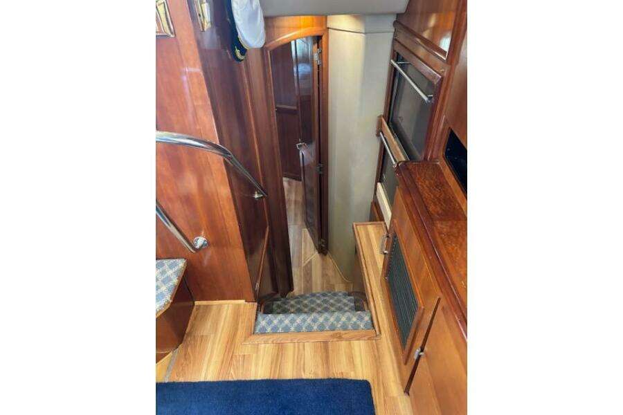Interior of 2004 Carver 466 Motor Yacht with wooden stairs and cabinetry.