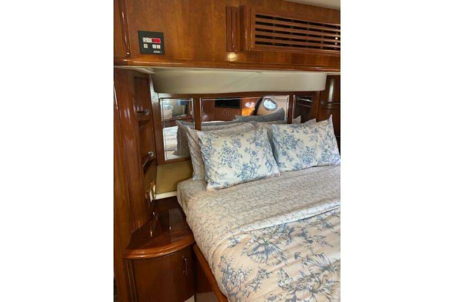 Luxurious bedroom interior of 2004 Carver 466 Motor Yacht with floral bedding.