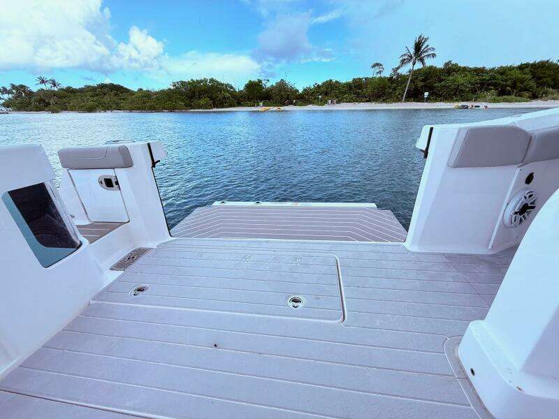 2024 Scout 400 LXF boat deck overlooking serene water and lush shoreline.