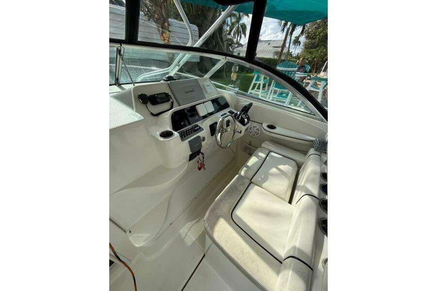 2002 Wellcraft 290 Coastal boat interior with steering wheel and seating area.